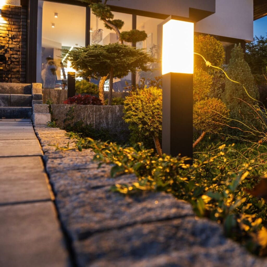 a solar light in the garden of a home at night